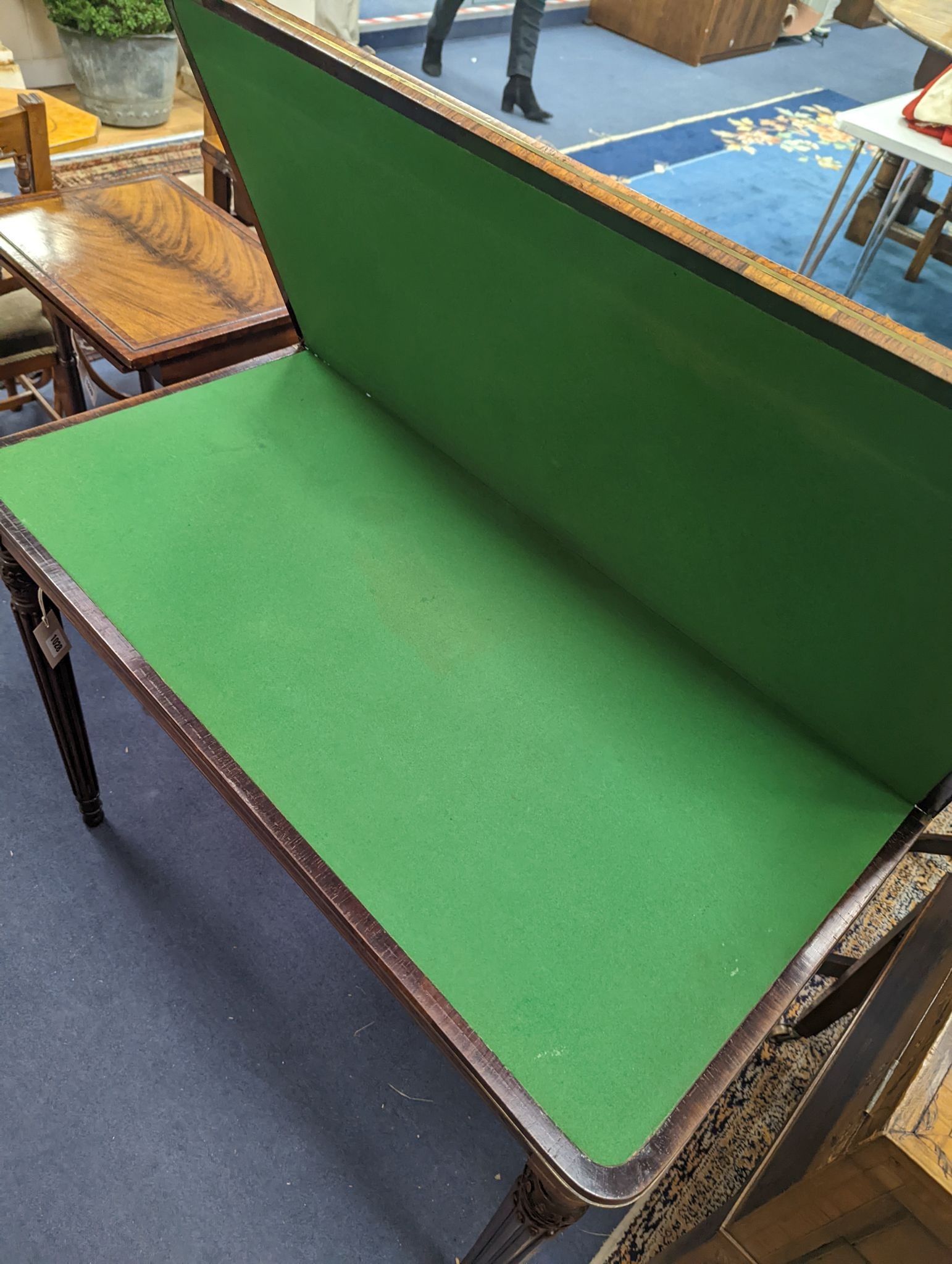 A Regency rosewood brass mounted rectangular folding card table with fluted legs, in the manner of Gillows, width 95cm, depth 47cm, height 75cm